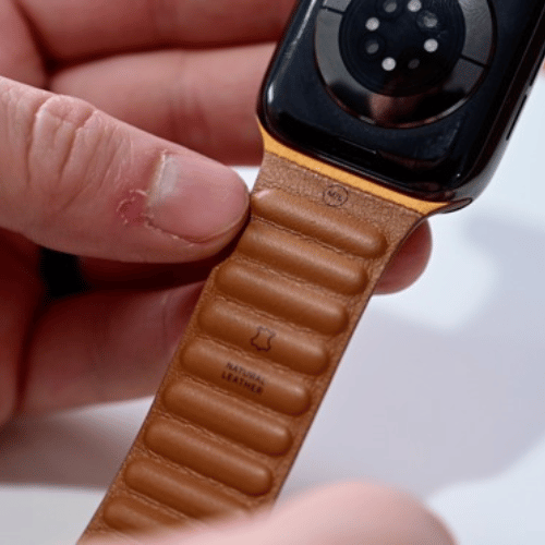 Apple Watch Leather Link-bandje getoond in verschillende kleuren op een effen achtergrond